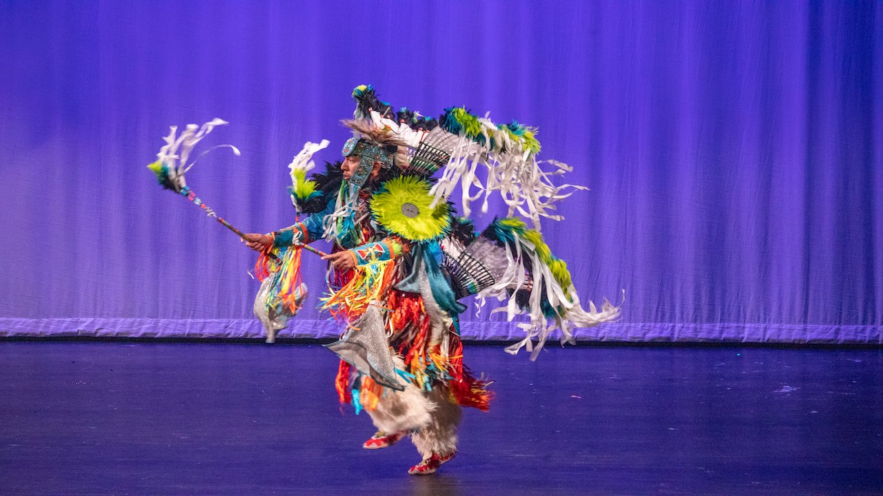 Man dancing in Native American clothing