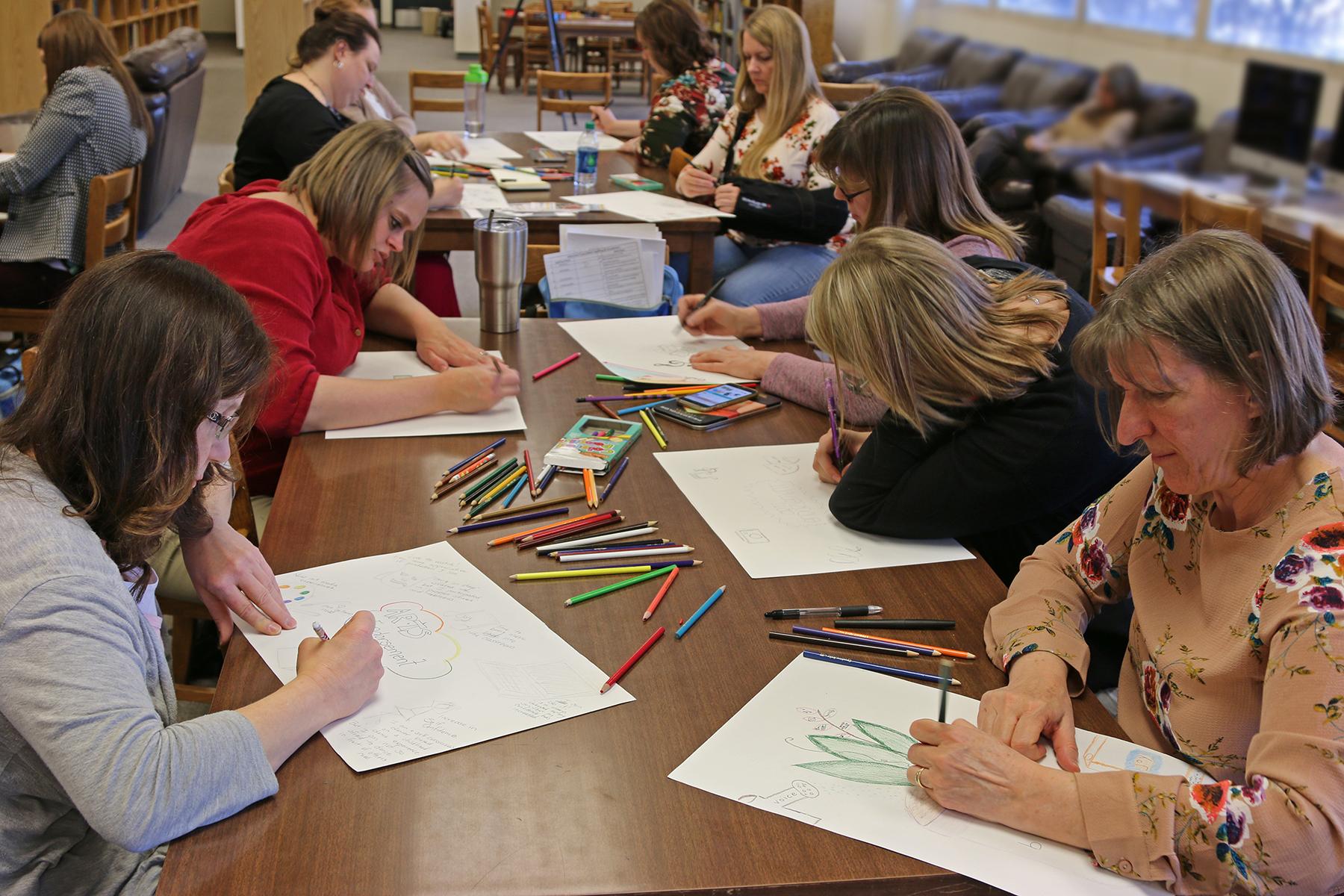 Teachers working on sketchbooks